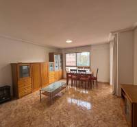 Living room with light furniture and a table, 4-room apartment, floor with wood decor.