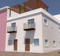 A family house in Villajoyosa with balconies, wooden doors, and a terrace with a pergola.