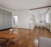 1-bedroom apartment with wood-patterned flooring, built-in wardrobes, and a kitchenette.