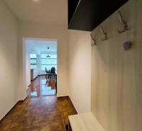 Hallway in a 2-room apartment, entrance to the living room with a dining table, floor with patterns.