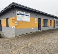 The car dealership on Bratislavská Street in Veľký Biel is surrounded by a paved area.