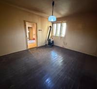 A room with wooden floor decor and a stove in a family house.