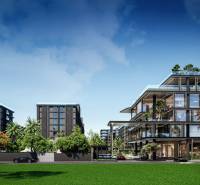 Apartment construction in Pattaya surrounded by greenery, modern buildings and cars in the background.