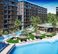 Apartment construction in Pattaya with a pool and palm trees offers a relaxing atmosphere.