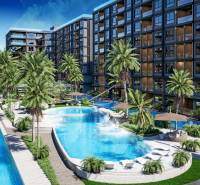 Apartment construction in Pattaya with pools, palm trees, and modern architecture in a tropical setting.