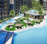 The construction of apartments in Pattaya with pools, loungers, and palm trees creates a holiday atmosphere.