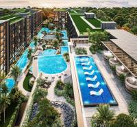Apartment construction in Pattaya with pools, green roofs, and abundant vegetation.
