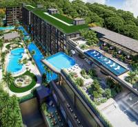 Apartment construction in Pattaya, featuring swimming pools and terraces with surrounding greenery.
