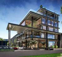 Construction of apartments in Pattaya with glass facades and greenery in the surroundings.