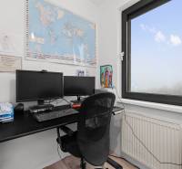 A workspace with a dual monitor and a world map in a 3-room apartment.