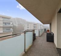 The balcony of a 3-room apartment with a view of the surrounding buildings in Bratislava - Karlova Ves on Bedlova Street.