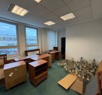 Offices with carpet flooring, furniture, and chandelier structures.
