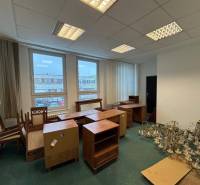 The interior of offices with furniture and chandeliers on a floor with wooden decor.