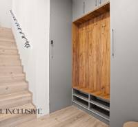 A staircase with a wooden decor floor and a built-in wardrobe in a 3-room apartment.