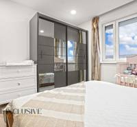 A children's room with a wooden decor floor, a wardrobe, and a crib in a 3-room apartment.