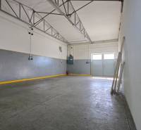Spacious warehouse interior with concrete floor and steel beams.