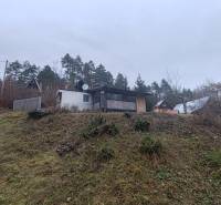 A cottage on a slope surrounded by nature on Main Street in Nova Kelc.