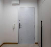 Entrance hallway in a 2-room apartment with white doors and built-in wardrobes.