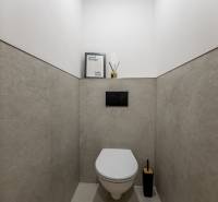 A bathroom in a 3-room apartment with minimalist decor and beige tiles.