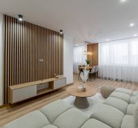 Living room in a 3-room apartment, wooden decor flooring, comfortable sofa, decorative walls.