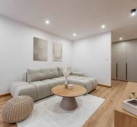 Living room in a 3-room apartment with a comfortable sofa and a wooden decor floor.