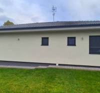 A family house in Studienka with a terrace, green lawn, and modern facade.