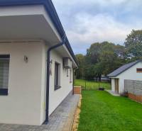 A family house in Studienka with a terrace, garden furniture, and a landscaped garden.