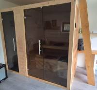 Interior of a family house with a sauna, fan, and a sink on a wooden table.