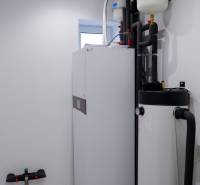 Bathroom equipment in a family house with boilers and pipes, light walls.