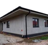 A family house in Radava with a simple facade and a sloped roof under construction.