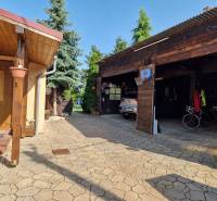A family house in Dlhá nad Váhom with a shelter, garage, and landscaped yard.