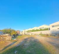 A view of family houses in Kolárovo with adjacent areas and a clear blue sky.