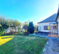 A family house in Neded with a landscaped garden, lawn, and a gazebo next to the house.