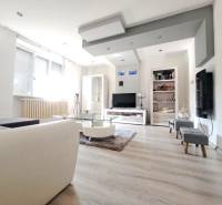 Living room in a family house with a wooden decor floor and a sofa.