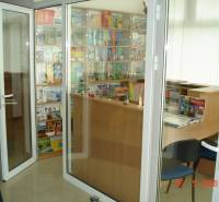 Glazed commercial spaces with books and brochures behind a wooden counter.