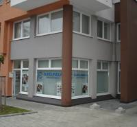 Commercial premises on Komárnická Street in Bratislava - Ružinov with large windows and an advertising sign.