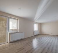 A bright room with a wood-decor floor in a family house, empty and ready.