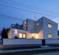 A family house on Trnovecká Street in Trnovec nad Váhom illuminated at dusk.