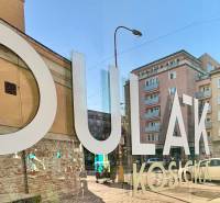 Reflection on the glass shows the facades of buildings on Dulovo Square, Bratislava - Nivy, 2-room apartment.