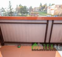 A balcony with a view of greenery from a 4-room apartment in the town of Veľký Krtíš on Hviezdoslavova Street.