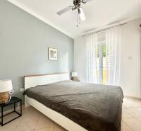 A bedroom in a holiday apartment with a double bed and nightstands.