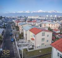 A view of terraced family houses in Poprad with the panorama of the Tatras in the background.