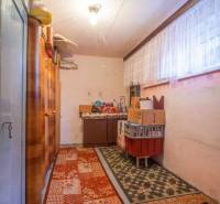 Storage space in a family house with carpets, shelves, and boxes.
