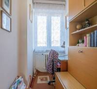A cozy corner in a family house with a desk and a bookshelf.