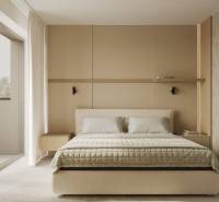 A bedroom with a bed, beige decor, and access to a balcony, decorated with a wall shelf.