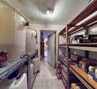 Storage space with shelves and barrels, full of food and drinks in a commercial area.