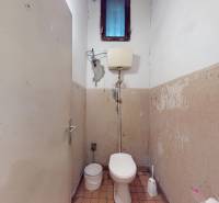 Old toilet with gray walls and a small window, from Bratislava - Petržalka, commercial premises.
