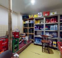 Warehouse of commercial premises with a stock of beverages and food, shelves and racks with goods.