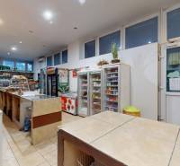 Interior of commercial spaces with various goods and lighting, including beverages and food.