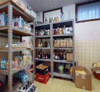 Storage space in commercial premises with shelves full of drinks and groceries.